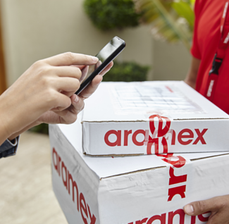 Aramex parcels being handled during a delivery